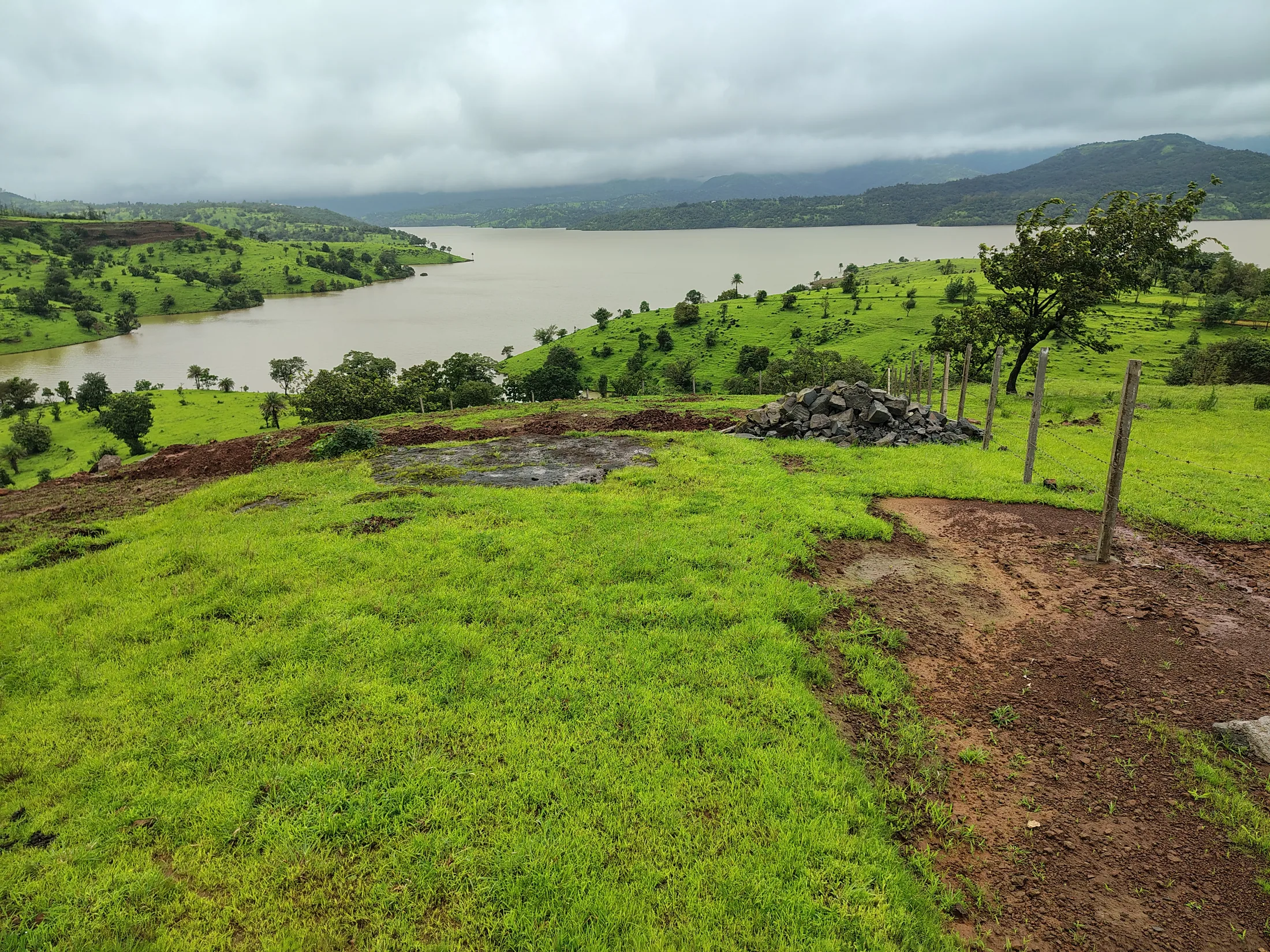 Wide view of green hills around the dam
