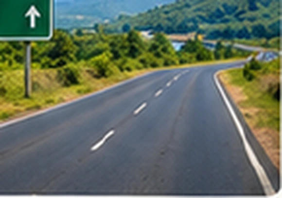 Paved highway winding through green hills near Bhor–Mahad